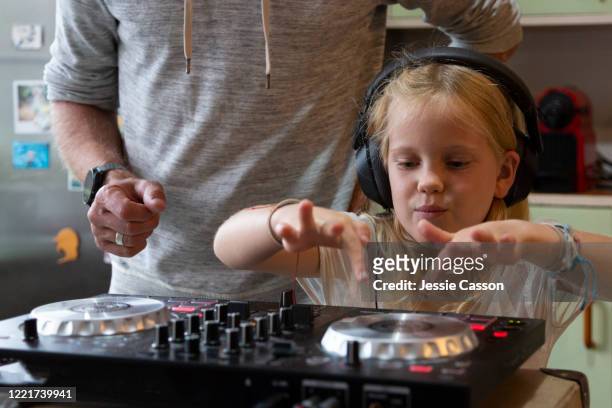 a young girl learns to dj in her kitchen - girl dj stock-fotos und bilder