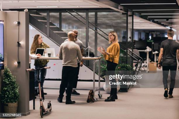 businesswoman discussing strategy with colleagues at office desk - sustainable office bildbanksfoton och bilder