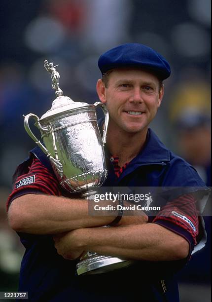 Payne Stewart of the United States celebrates victory with the trophy after winning the 1999 US Open Tournament played on the number two course at...