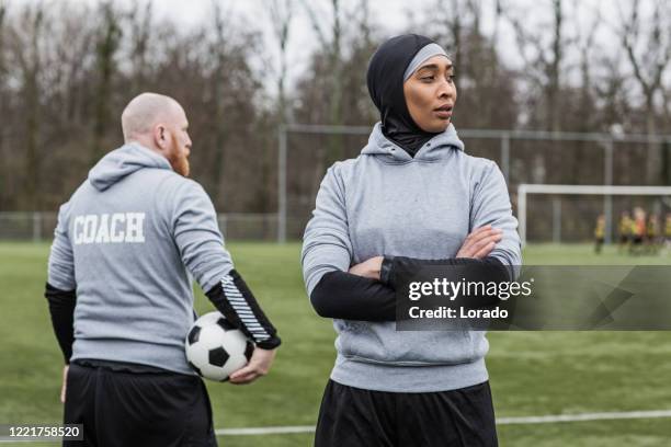 beautiful young female muslim soccer player and coach - amateur stock pictures, royalty-free photos & images