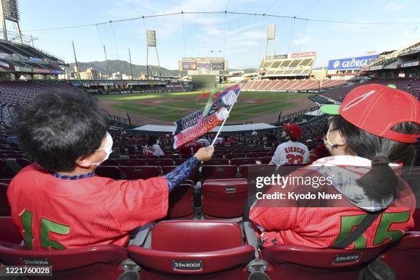 Public viewing is held for a limited number of fans at Mazda Stadium in Hiroshima on June 19 as the Hiroshima Carp played their season opener in...