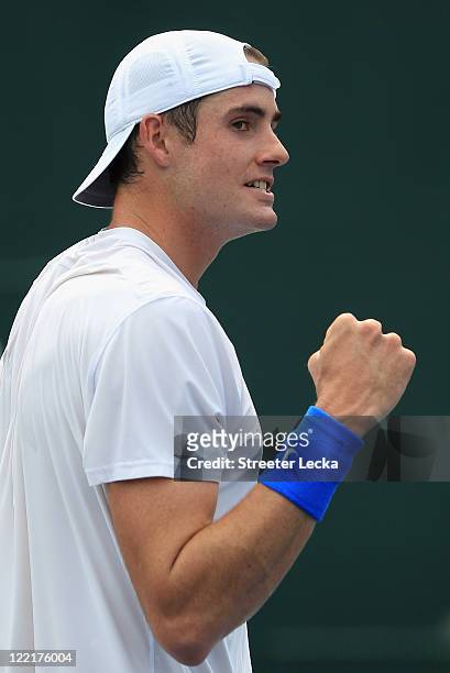 John Isner of the USA celebrates after defeating Andy Roddick of the USA during the semifinals of the Winston-Salem Open at the Wake Forest...