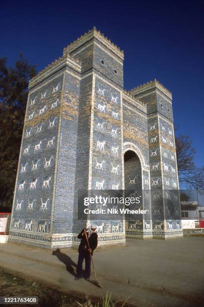 Worker sweeps forecourt to restored Lions Gate, entrance to ruins of Babylon, one of the seven Wonders of the Ancient World, circa 1978;