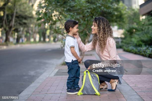 happy mother taking her son to school - goodbye single word stock pictures, royalty-free photos & images