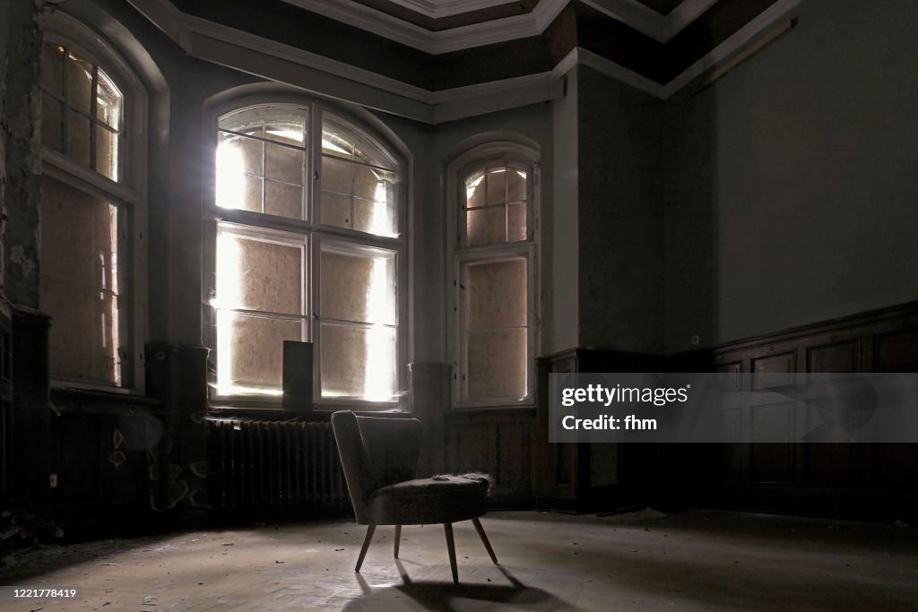 Chair in an empty room in an abandoned building