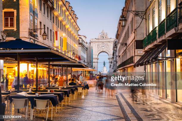 tourists in the city center of lisbon at night, portugal - lisbon stock pictures, royalty-free photos & images