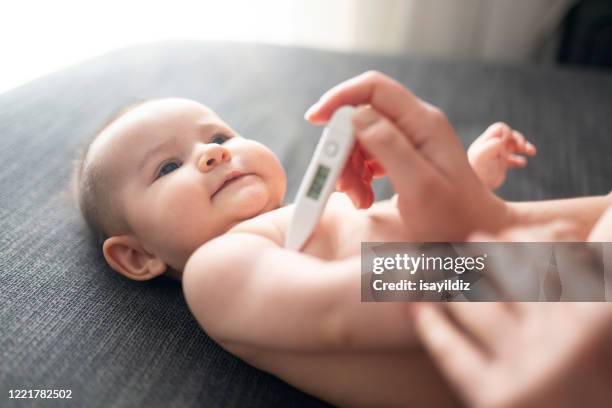 baby with thermometer - digital thermometer stock pictures, royalty-free photos & images
