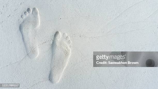 human footprints feet on the sand. copy space - footprint stock pictures, royalty-free photos & images