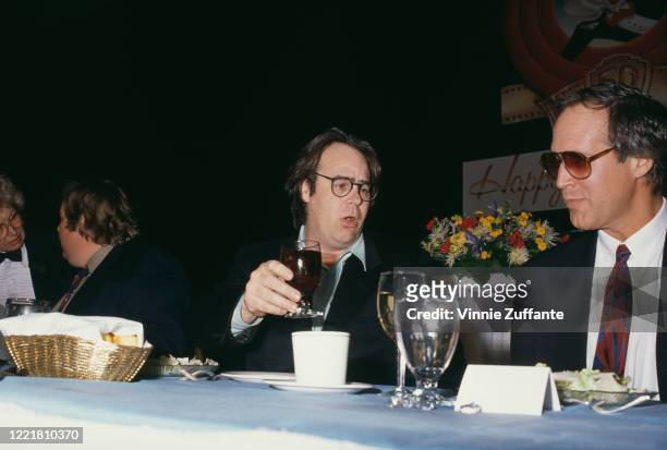Canadian actor and comedian John Candy , Canadian actor and comedian Dan Aykroyd, and American actor and comedian Chevy Chase attend the 1990 ShoWest...
