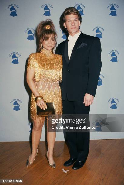 American singer and dancer Paula Abdul and American actor Patrick Swayze attend the 1990 Grammy Awards, held at the Shrine Auditorium in Los Angeles,...