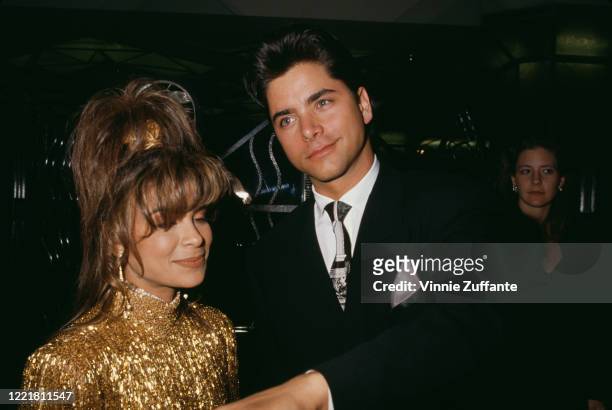 American singer and dancer Paula Abdul and American actor John Stamos attend the 1990 Grammy Awards, held at the Shrine Auditorium in Los Angeles,...