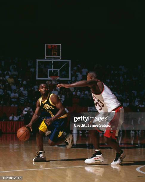 Tony Miller#10, Guard for the Marquette University Golden Eagles dribbles past Darnell Burton, Guard for the University of Cincinnati Bearcats during...