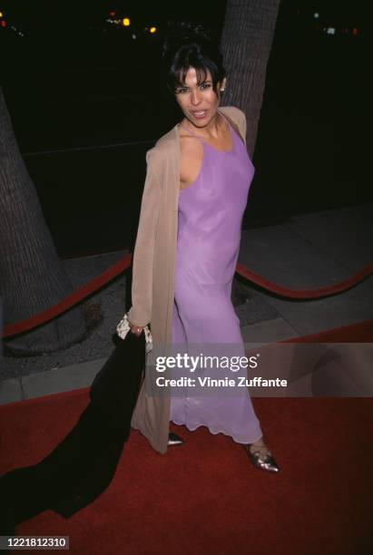 Cuban actress and singer Maria Conchita Alonso, wearing a full-length lilac dress, attends the premiere of 'The Saint' held at the Academy Theater in...