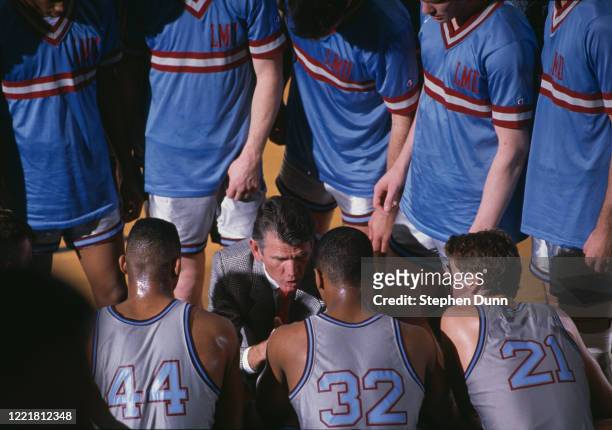 Paul Westhead, head coach for the Loyola Marymount University Lions talks run and gun play system to his players Hank Gathers, #32 Enoch Simmons and...