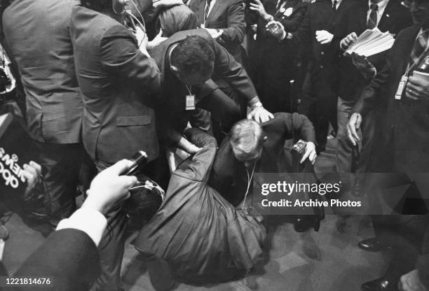 Reporter is thrown to the ground in a scuffle with security staff on the third day of the 1968 Democratic National Convention, held at the...