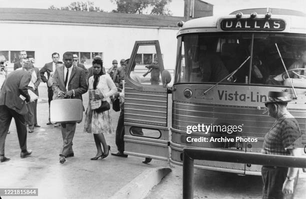 Civil rights activists known as the Freedom Riders disembark from their bus , en route from Montgomery, Alabama, to Jackson, Mississippi, as they...