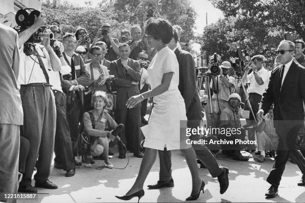 American students Vivian Malone and James Hood walk through the crowds as they become the first African American students to enrol at the University...