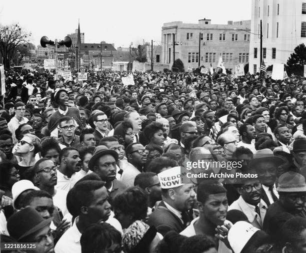 Civil rights protesters, demonstrating against voter registration laws in the state of Alabama, at the conclusion of the third leg of their march...