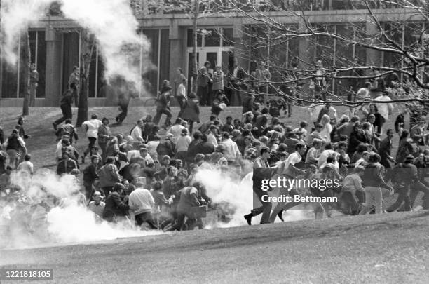 Youths flee as they try to escape exploding tear gar fired into their midst by National Guardsmen on the Kent State University campus.
