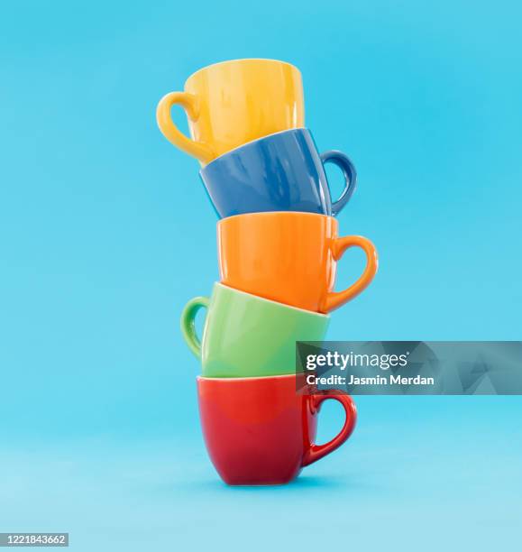 stack of coffee cups on blue pastel background - stacking stock pictures, royalty-free photos & images