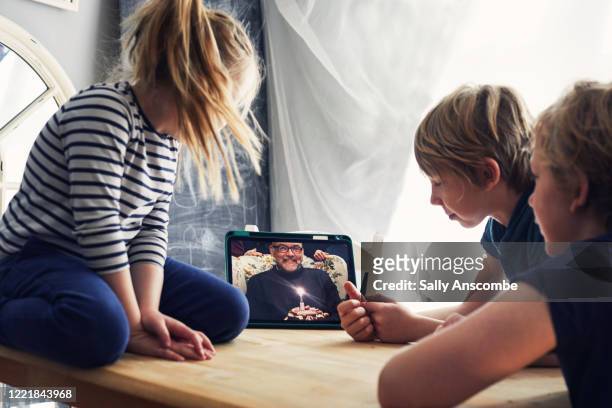 family celebrating a birthday together on a video call - zoom birthday stock pictures, royalty-free photos & images
