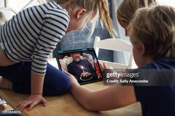 family celebrating a birthday together on a video call - zoom birthday stock pictures, royalty-free photos & images