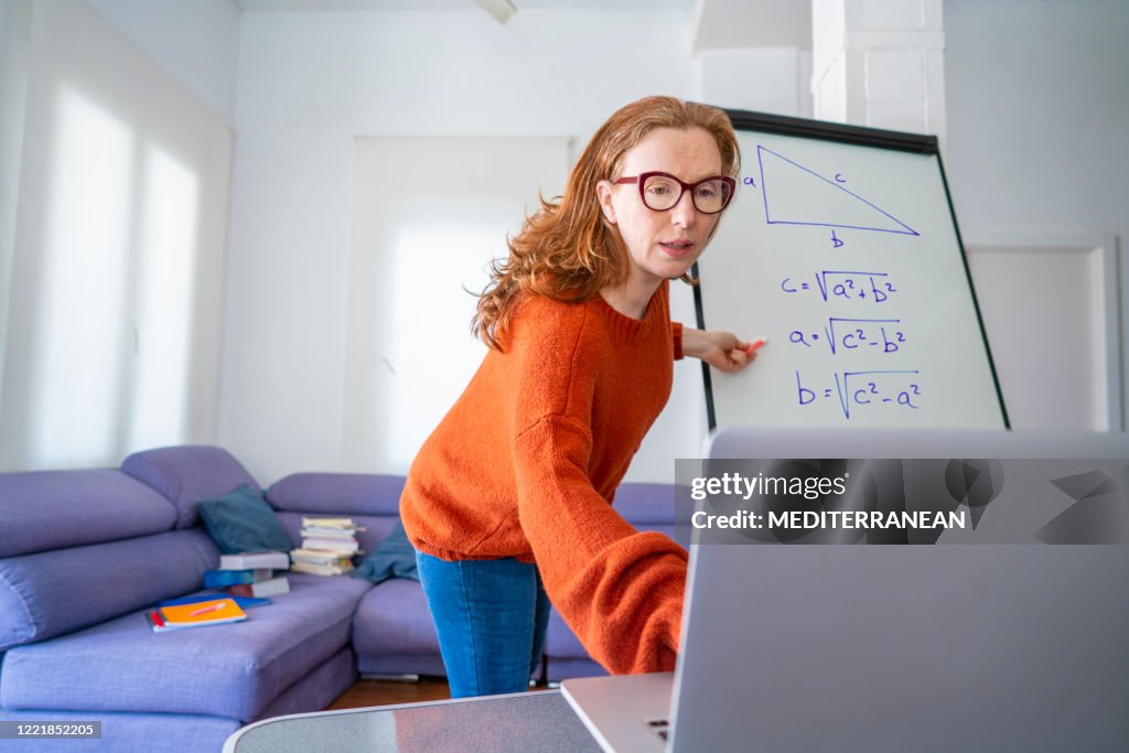 Teacher woman teaching remotely from home Maths class