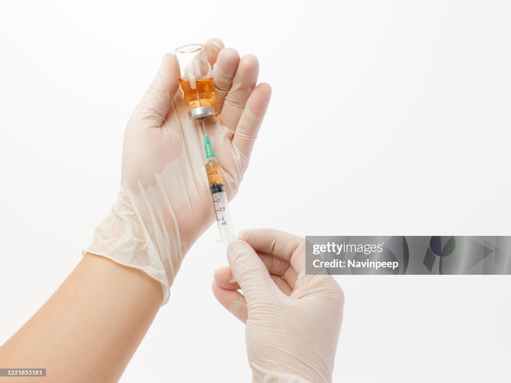 Hand Using A Syringe Hands Holding Syringe High-Res Stock Photo - Getty Images