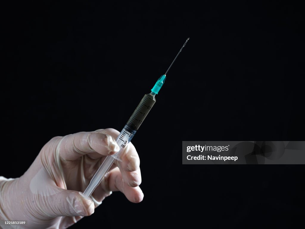Hand Using A Syringe Hands Holding Syringe High-Res Stock Photo - Getty Images