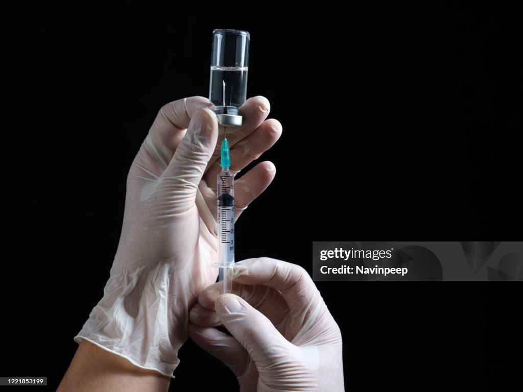 Hand Using A Syringe Hands Holding Syringe High-Res Stock Photo - Getty Images