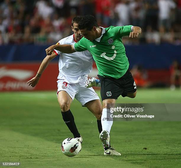 No 3 Fernando Navarro from FC Sevilla and Schmiedebach Hannover 96 during the UEFA Europa League Play-Off second leg match between FC Sevilla and...