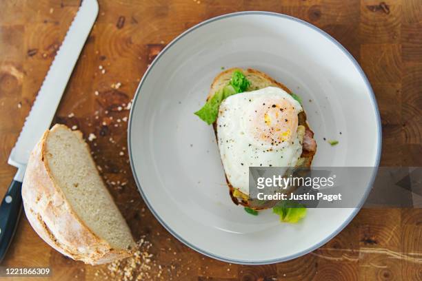 fried egg on homemade toasted bread - bread knife stock pictures, royalty-free photos & images