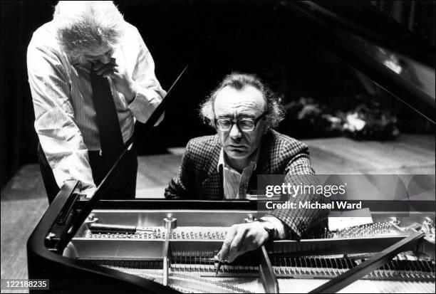 Pianist Alfred Brendel and piano technicain Bob Glazebrook 'voicing' the piano, to adjust the instrument's tone, Queen Elizabeth Hall, 1982.