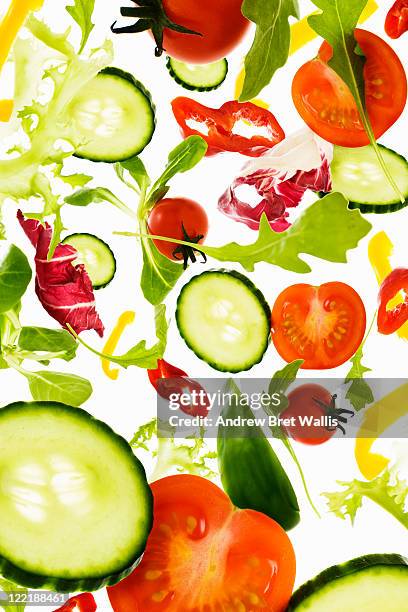 fresh mixed salad vegetables falling to camera - low calory diet stock pictures, royalty-free photos & images