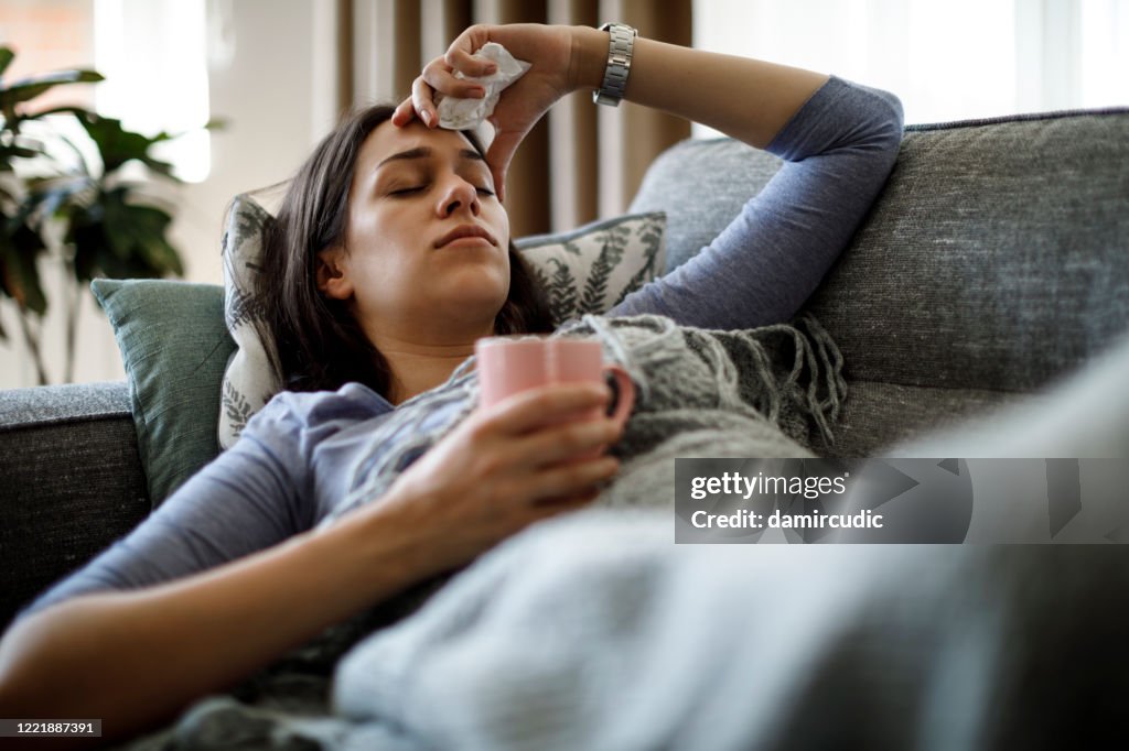Sick woman lying in bed