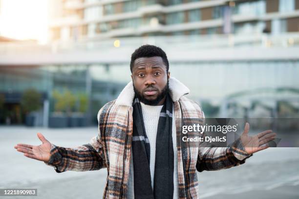 confused man looking at camera. - manquestionmark stock pictures, royalty-free photos & images