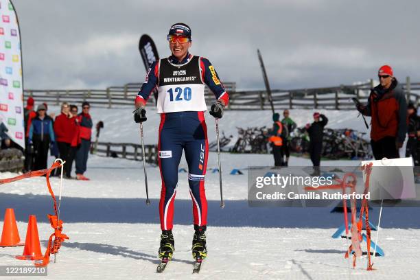 Justyna Kowalczyk of Poland celebrates crossing the line after the Winter Triathlon during day 15 of the Winter Games NZ at Snow Farm on August 27,...