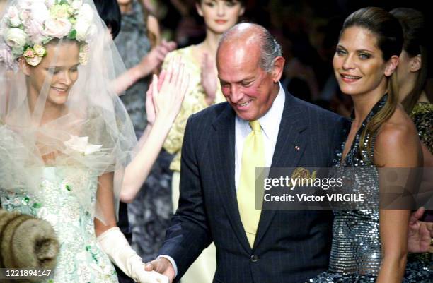 Carmen Kass the bride and fashion designer Oscar de la Renta walk the runway during the Balmain Haute Couture Fall/Winter 2000-2001 fashion show as...