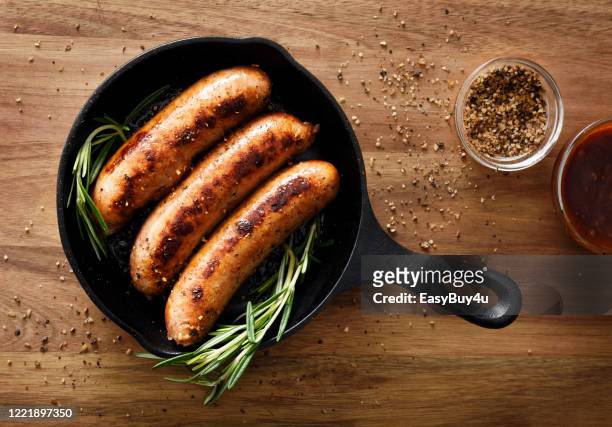 sausages in a skillet - sausage stock pictures, royalty-free photos & images