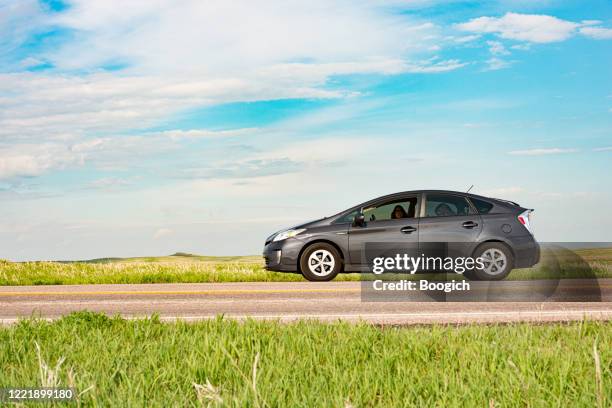 hybrid toyota prius parked by the road in badlands national park south dakota - toyota prius stock pictures, royalty-free photos & images