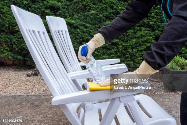 wiping down surfaces - garden chairs - garden furniture foto e immagini stock
