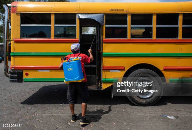 Man disinfects intercity bus units traveling to the west of the country in the Israel Lewites market area on April 29, 2020 in Managua, Nicaragua....