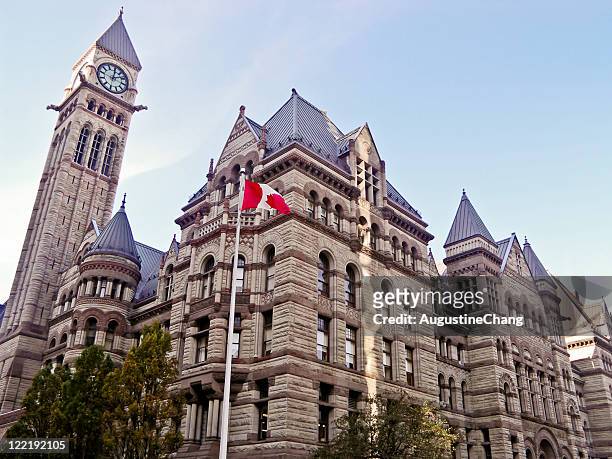 a building in toronto with the canadian flag out front - toronto ontario stock pictures, royalty-free photos & images