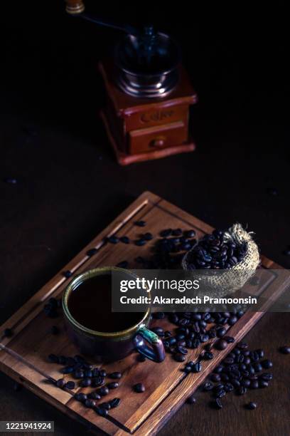 hot espresso and coffee bean on black table with soft-focus and over light in the background - softfocus stock pictures, royalty-free photos & images