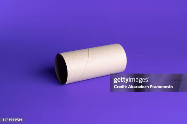 empty paper in toilet rolls on a purple background - toilet paper stock pictures, royalty-free photos & images