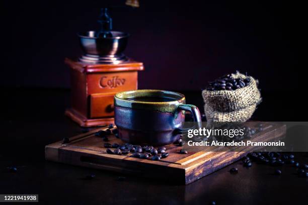 hot espresso and coffee bean on black table with soft-focus and over light in the background - softfocus stock pictures, royalty-free photos & images