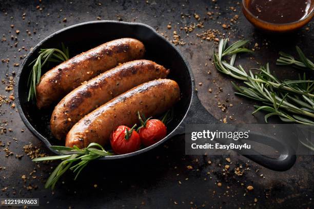 sausages in a skillet - beef sausage stock pictures, royalty-free photos & images