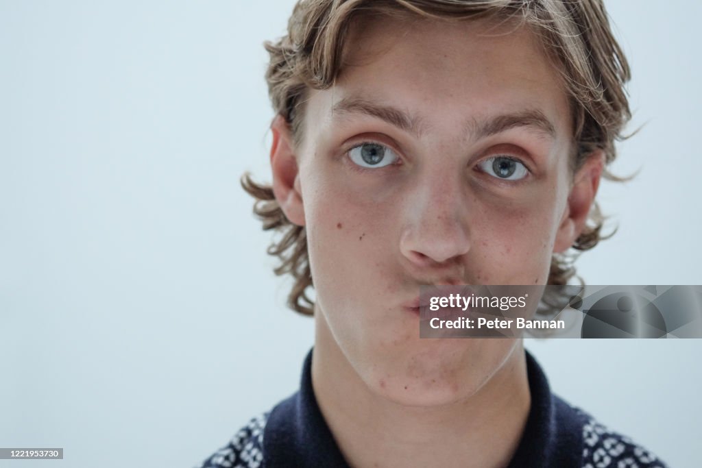 Stylish, attractive young man with mid length curly hair, close-up face