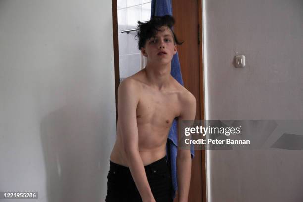 stylish teenage male, shirtless coming from bathroom - guy with attitude mid shot stock-fotos und bilder
