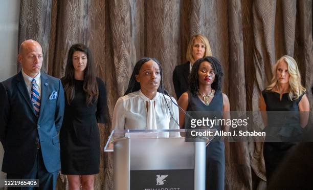 Shernae Hughes, second from right, listens as Janesha Morgan, center, both Black survivor of alleged sexual assault by former USC gynecologist George...